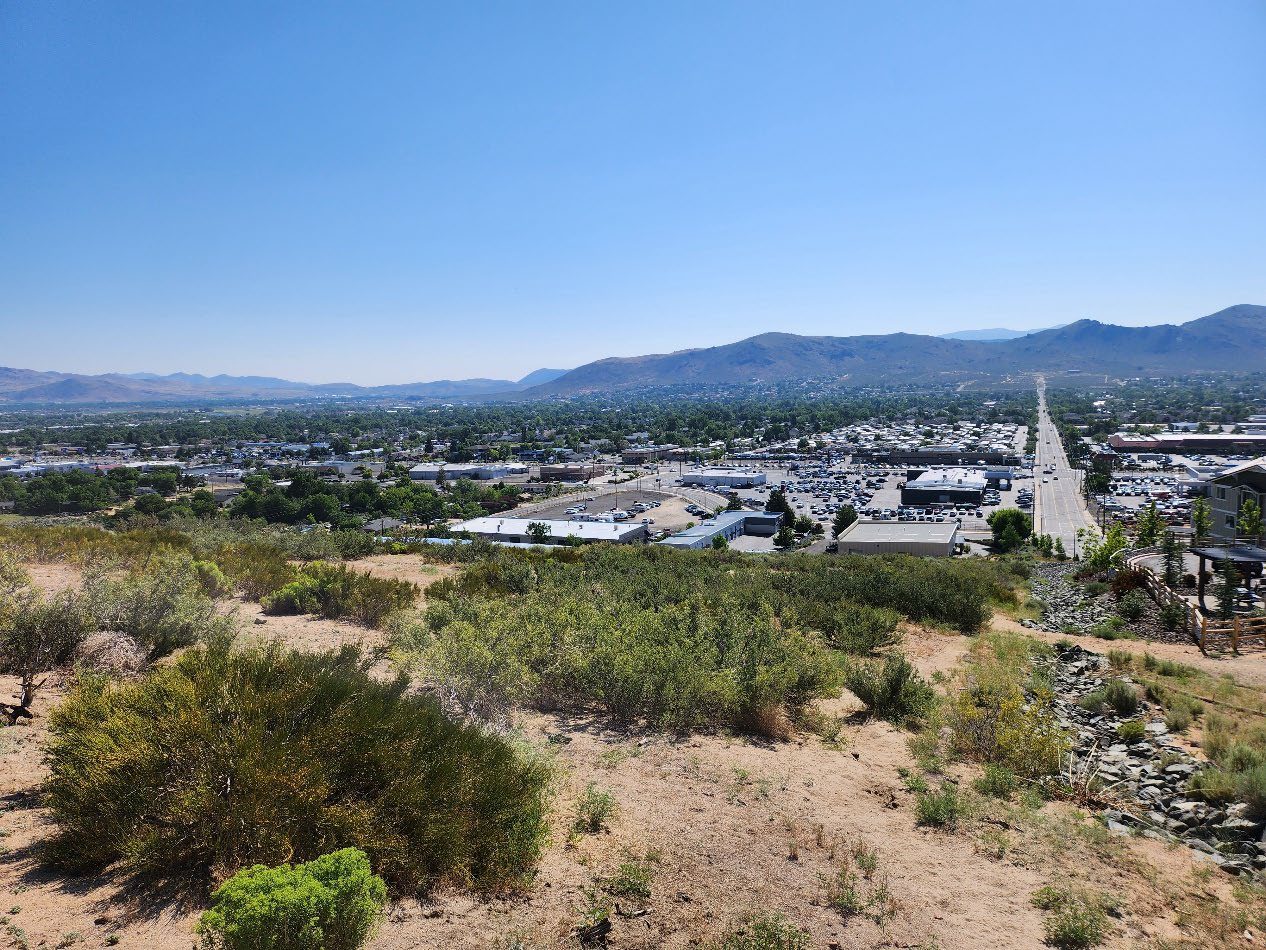 A view of the city from above looking down on the mountains.