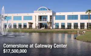 A large building with water in front of it.