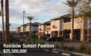 A view of a sunset pavilion with palm trees in the background.