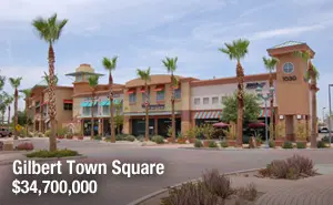 A view of a town square with many shops.